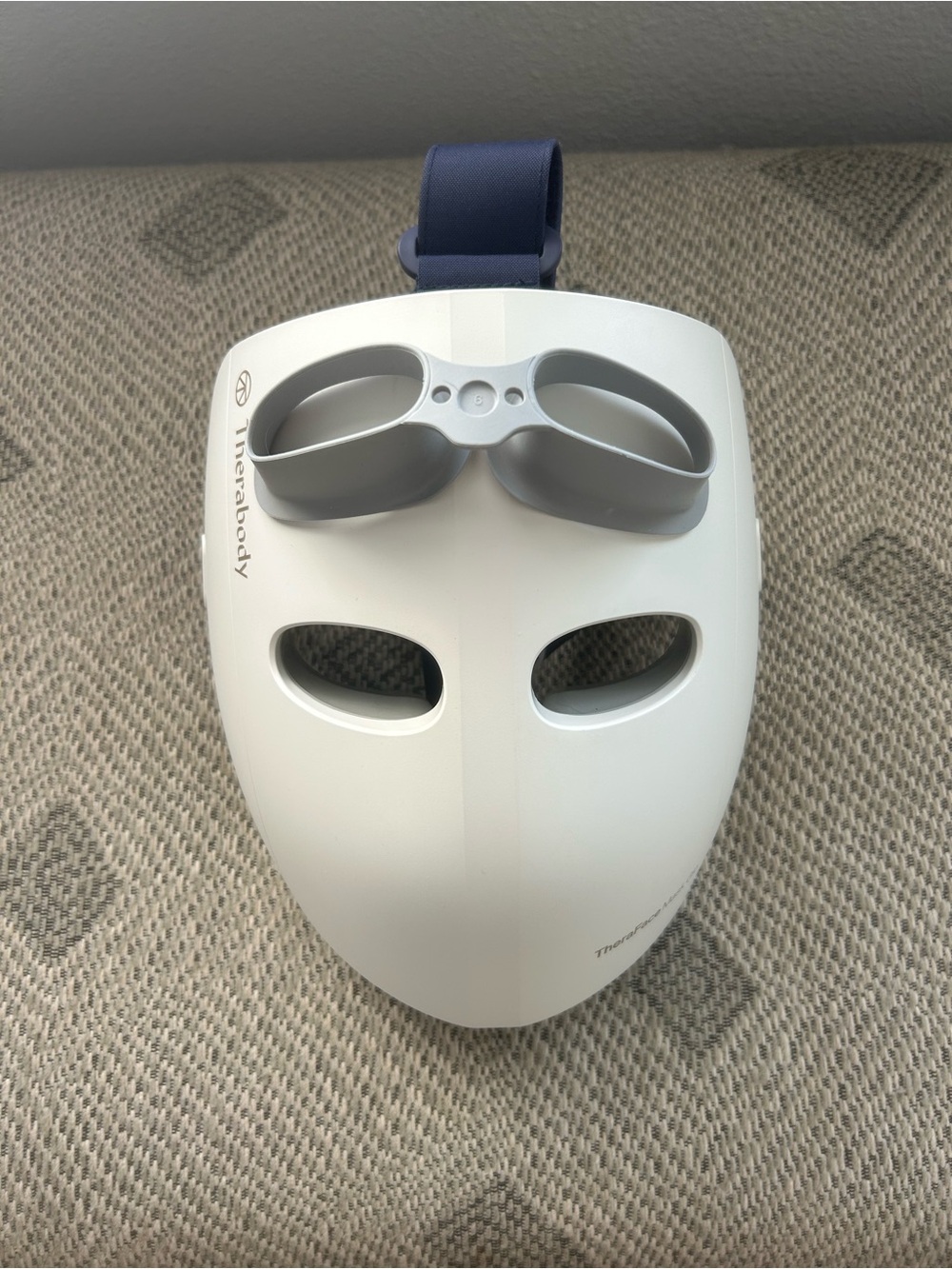 Therabody LED Facial Mask in White with Gray Accents and Navy Strap